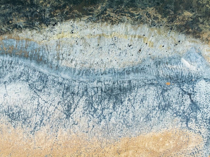 Abstract saline patterns at the edge of the Walvis Bay salt works. Aerial view. Drone shot. Namibia