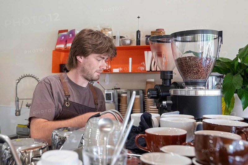 Midland, Michigan - An employee makes coffee at Chef Sergey's Bakery, a popular shop owned by four refugees from Ukraine. Several hundred thousand Ukrainians have been granted refugee status in the U.S. since Russia invaded their homeland, but the Trump Administration is considering whether to revoke their legal status