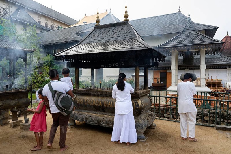 Temple of the sacred Tooth Relic or Sri Dalada Maligawa, Pilgrims burning incense, Kandy, Sri Lanka