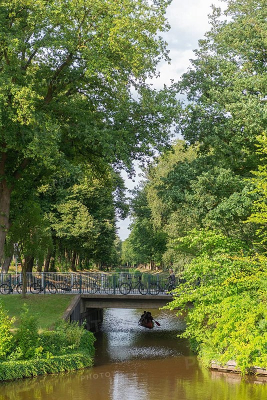 Historic peat canal to the peat harbour at the Bürgerpark from 1866, canoe, bridge, bicycles, attraction, leisure, recreation, groups of trees, nature, city state of Bremen, Germany