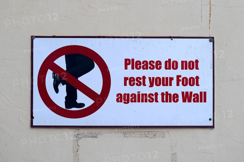 Prohibition sign Please do not lean your foot against the wall, Abu Dhabi, United Arab Emirates