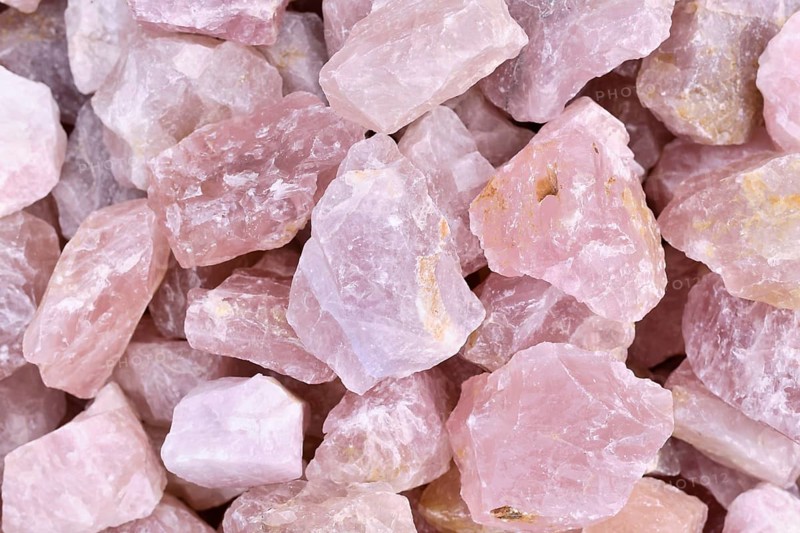Close up of raw large rose quartz crystals. Natural pink gemstone chunks used for healing or decoration