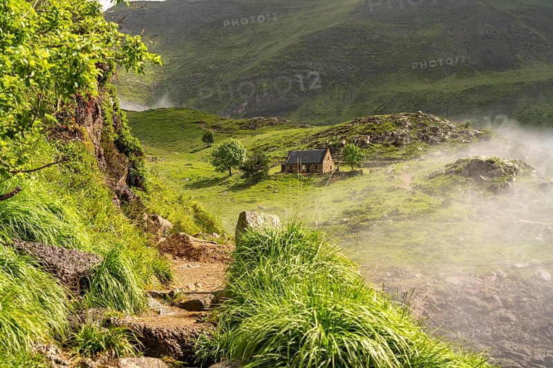 Hiking trail and mountain hut at the Lac des Gloriettes reservoir in the Pyrenees near Gavarnie-GÃ¨dre, France