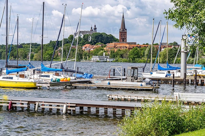 Sailing school on the GroÃŸer Plöner See, Nikolai Church and Plön Castle in Plön, Schleswig-Holstein, Germany