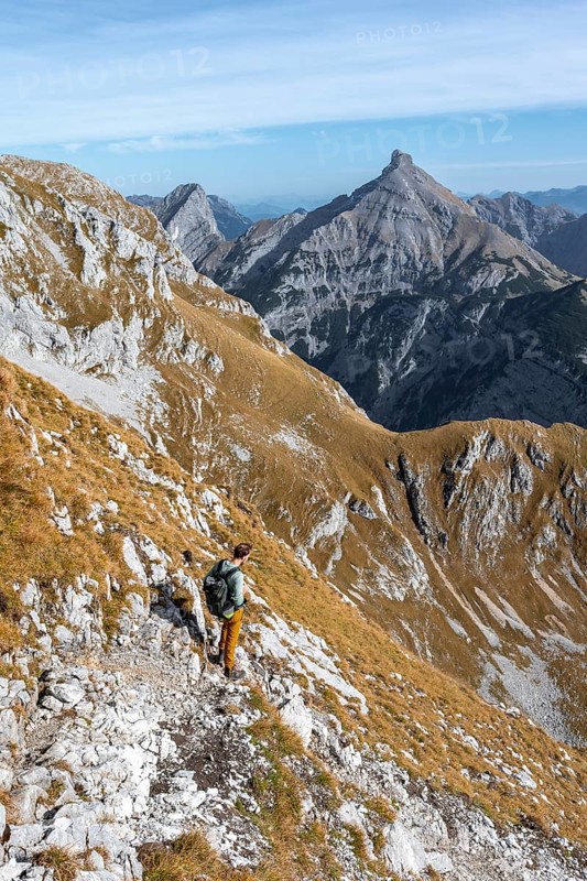 Mountain panorama with picturesque mountain landscape, mountaineers descending from the Gamsjoch, behind mountain peaks Sonnjoch and Schaufelspitze, in autumn, RiÃŸtal in the Eng, Karwendel, Tyrol, Austria