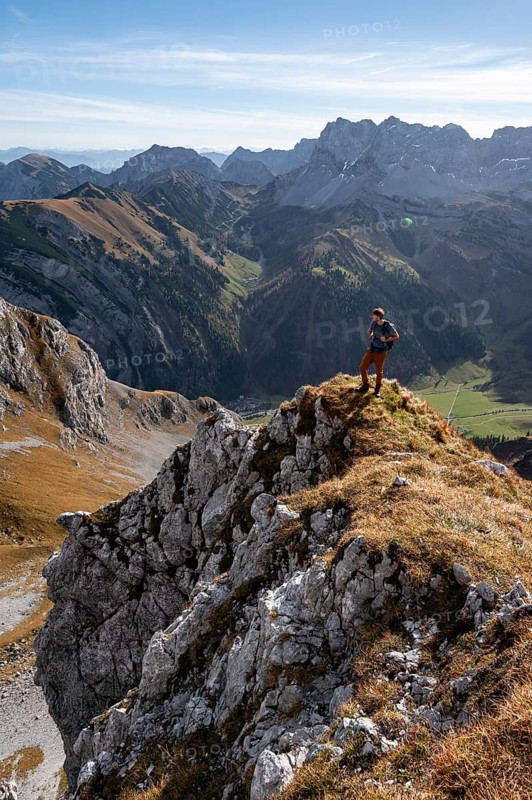 Mountaineers on a hiking trail on the Gamsjoch, picturesque mountain landscape in autumn, view of rocky mountain ridge, RiÃŸtal in the Eng, Karwendel, Tyrol, Austria