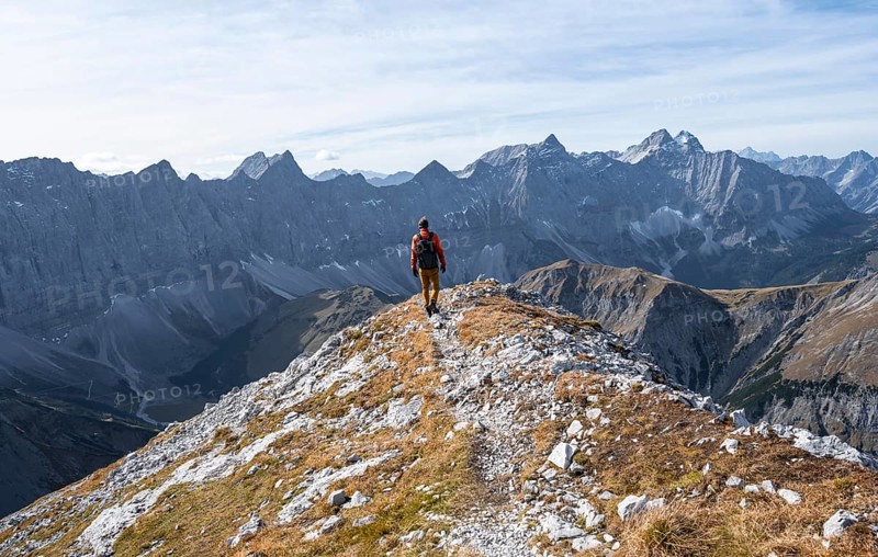 Mountain panorama with picturesque mountain landscape, mountaineers descending from the Gamsjoch, mountain ridge of the Hinterautal-Vomper chain behind, in autumn, RiÃŸtal in the Eng, Karwendel, Tyrol, Austria