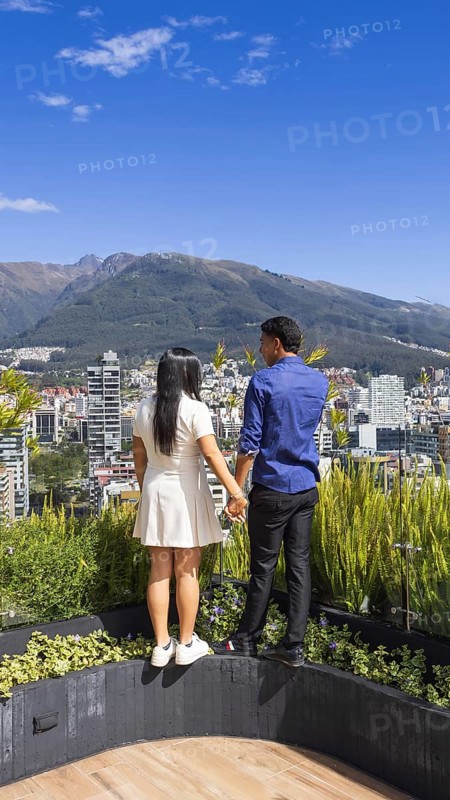 Quito, Ecuador, May 2 2025: Young tourist couple overview Carolina Park modern condominiums in Quito central business financial district
