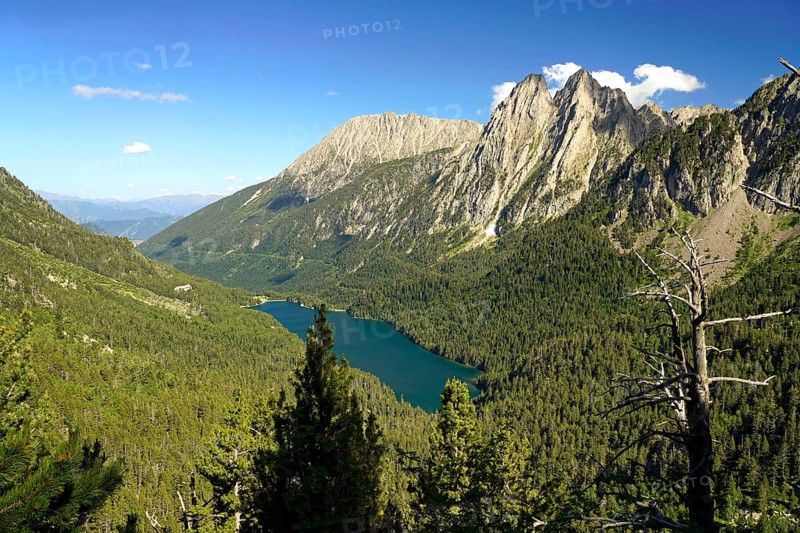 Lake Estany de Sant Maurici and the Els Encantats mountain range in the AigÃ¼estortes i Estany de Sant Maurici National Park seen from above, Catalonia, Spain