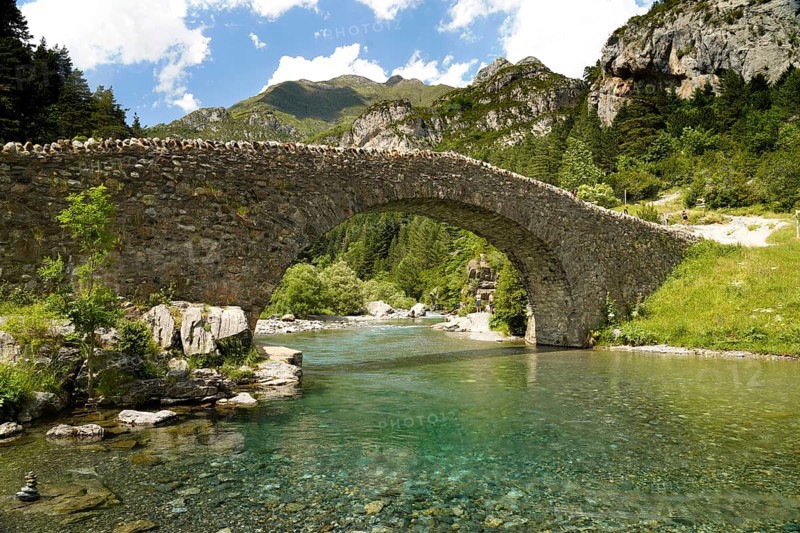 The Romanesque bridge Puente RomÃ¡nico de San NicolÃ¡s de Bujaruelo over the River Ara in the Bujaruelo Valley or Valle de Bujaruelo near Torla-Ordesa, Spain