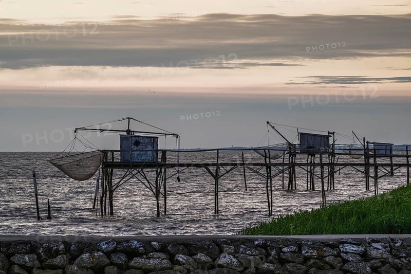 Sunset over Fishing huts over Gironde Estuary, Braud-et-Saint-Louis, France