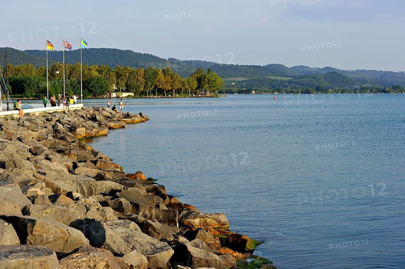 Quay with breakwater made of boulders, Bolsena marina, Porto Turistico di Bolsena, Lake Bolsena, Lago di Bolsena, volcanic crater lake, calm smooth water surface, Bolsena, Province of Viterbo, Lazio, Italy