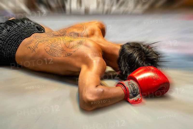Mop-up picture Muai Thai boxer knocked out on the ground, Pattaya, Thailand