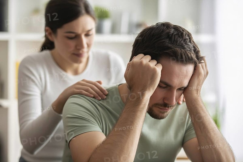 Frustrated man while woman comforts him. Concept of mankeeping and women's invisible emotional labor in relationships. Generative ai, AI generated