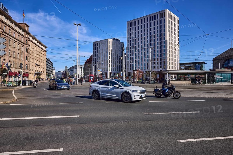 Traffic area, modern architecture, general building development, overhead lines, vehicles, cars, motorbike, lantern, blue sky, cirrostratus clouds, intersection Bahnhofsplatz with BahnhofstraÃŸe, Nuremberg, Middle Franconia, independent city, Bavaria, Germany