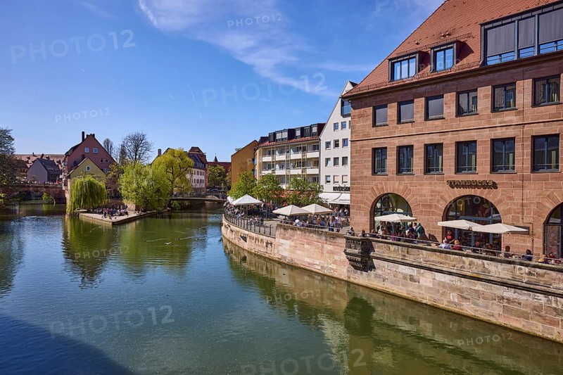 Flea market island, river Pegnitz, river island, pedestrian bridges, historic buildings, trees, reflections, water surface, Starbucks, outdoor area, gastronomy, parasols, visitors as secondary motif, backlight, blue sky, cloudless, KarlsbrÃ¼cke, Schleifersteg, Nuremberg, Middle Franconia, independent city, Bavaria, Germany