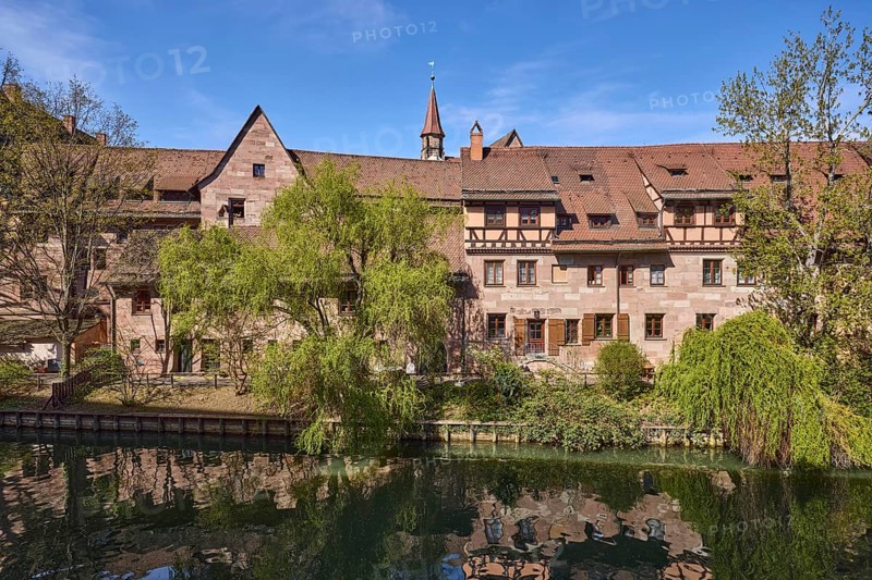 River Pegnitz, historic buildings, Babylon willow (Salix babylonica), trees, symmetrical reflections, water surface, blue sky, cirrostratus clouds, Vordere Insel SchÃ¼tt, Nuremberg, Middle Franconia, independent city, Bavaria, Germany