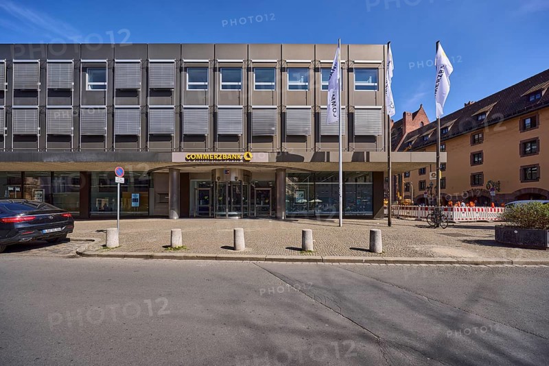 Commerzbank, modern architecture, flags, flagpoles, entrance area, barrier bollards, parking lane, vehicle, blue sky, cirrostratus clouds, alleyway Spitalgasse, Nuremberg, Middle Franconia, independent city, Bavaria, Germany