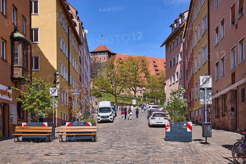 Street, traffic sign end of pedestrian zone, cobblestones, flower pots, benches, historical buildings, general architecture, castle, Kaiserburg, blue sky, cloudless, BurgstraÃŸe, Nuremberg, Middle Franconia, independent city, Bavaria, Germany