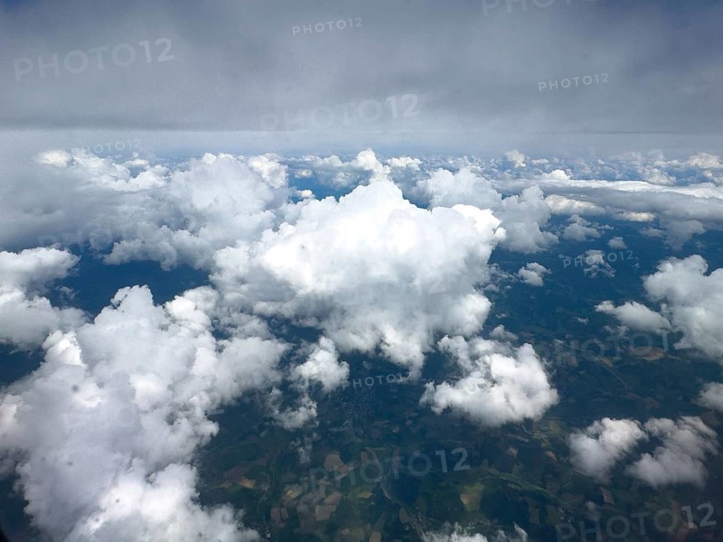 View from aeroplane at high altitude of white bright cluster clouds Altocumulus above darker Altostratus, international
