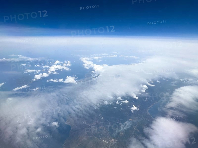 View from aeroplane at high altitude on white clouds Altostratus moving over coastal region of Mediterranean, Greece