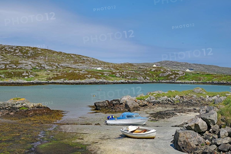 Two boats on a rocky shore in a quiet bay under a clear sky in front of hills, Idyll, Outer Hebrides, South Uist, Scotland, Great Britain