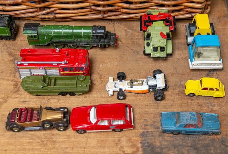 A selection of children's toy cars trucks train for sale on display at auction, UK