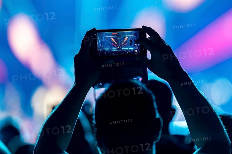 A concertgoer films Lionel Richie with his smartphone on the Say Hello To The Hits 2025 Tour at the Uber Arena in Berlin on 3 July 2025