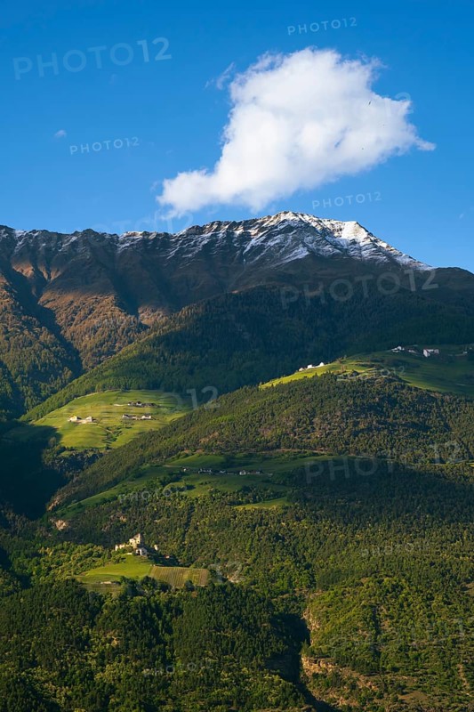 View of the Sonnenberg with Annenberg Castle and the farms above in the evening light, Dolomites, South Tyrol, mountains, Laces, Morter, Italy
