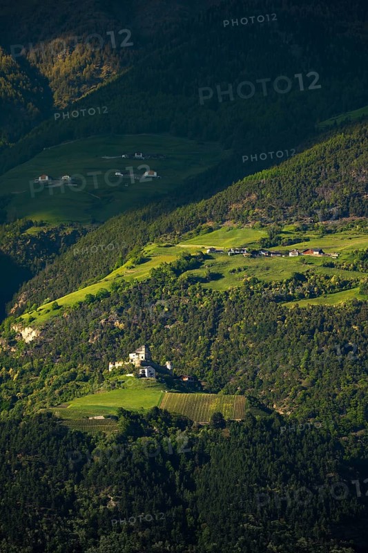 View of the Sonnenberg with Annenberg Castle and the farms above in the evening light, Dolomites, South Tyrol, mountains, Laces, Morter, Venosta Valley, Italy