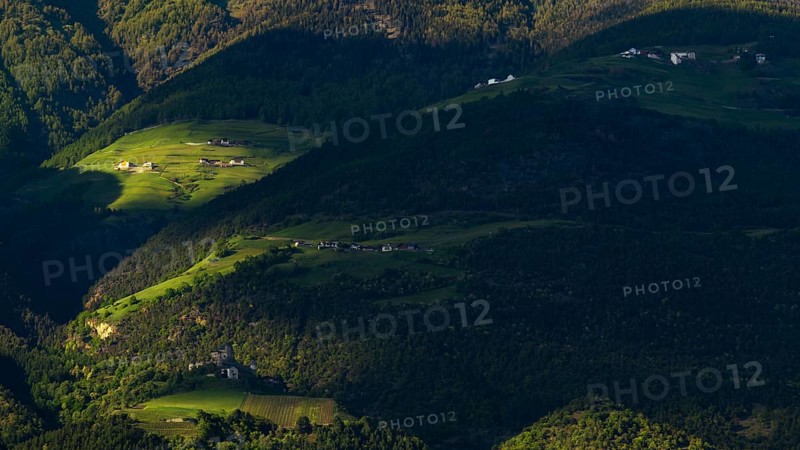 View of the Sonnenberg with Annenberg Castle and the farms above in the evening light, Dolomites, South Tyrol, mountains, Laces, Morter, Italy