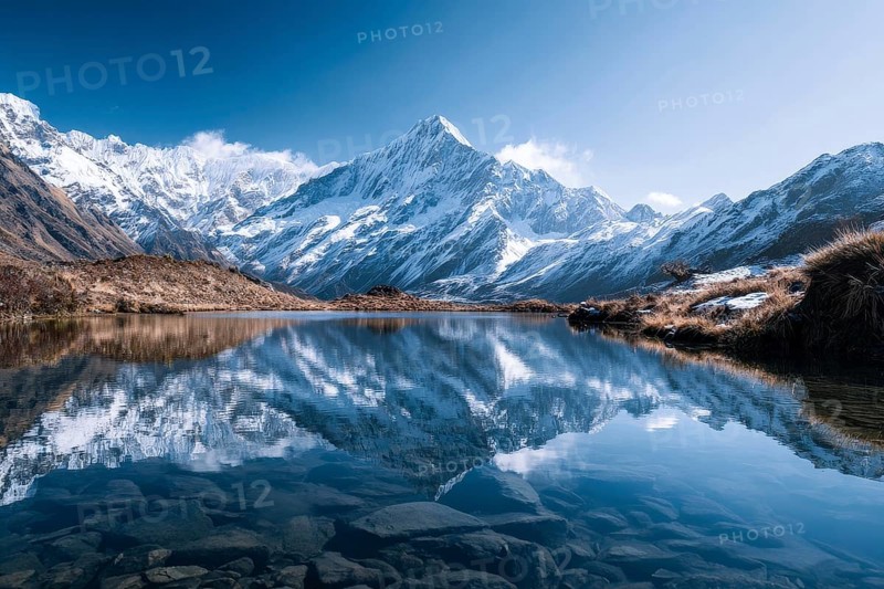 Alpine snow-peaked mountain landscape with trees reflecting in the water of pristine lake, AI generated