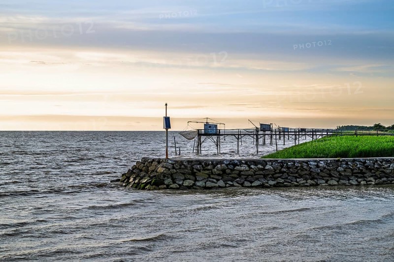 Sunset over Fishing huts over Gironde Estuary, Braud-et-Saint-Louis, France