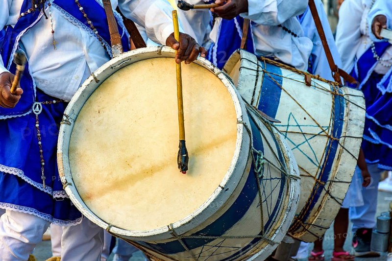 Musicians with their rustic wooden drums and colorful clothes during the religious festival of Congado in Minas Gerais, Minas Gerais, Brazil