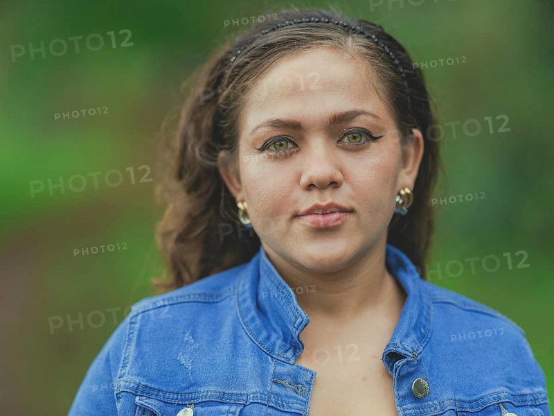 Portrait of attractive latin girl smiling outdoors. Close up of Latin American girl face looking and smiling at the camera