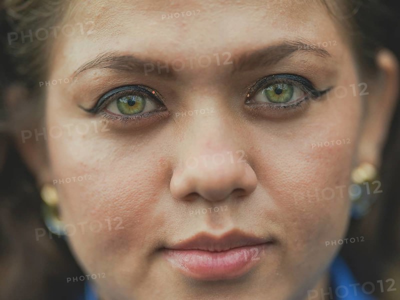Close up of Latin American girl face looking and smiling at the camera. Portrait of attractive latin girl smiling outdoors