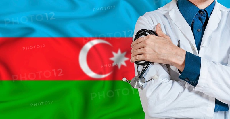 Doctor with stethoscope on Azerbaijan flag. Doctor holding stethoscope on Azerbaijan flag