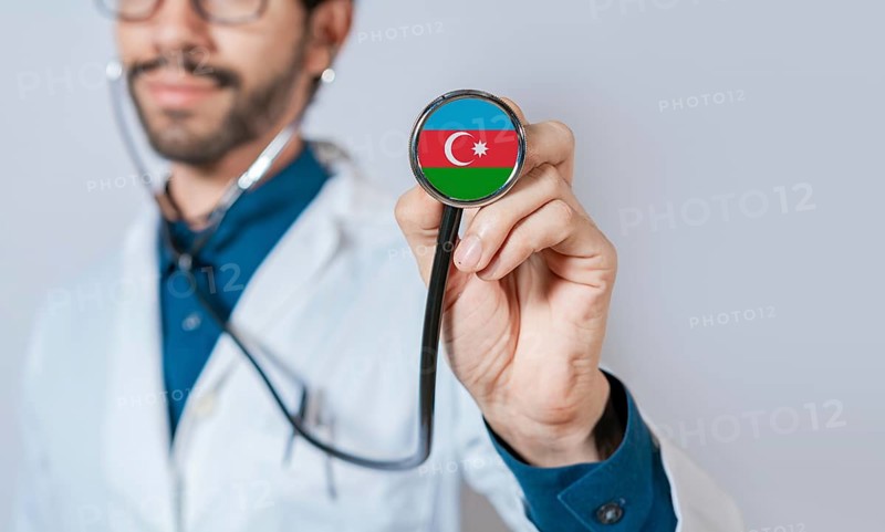 Doctor holding stethoscope with Azerbaijan flag. Azerbaijan health and care concept, Azerbaijan flag on stethoscope