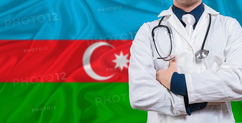 Male doctor with stethoscope on Azerbaijan flag. Doctor holding stethoscope on Azerbaijan flag