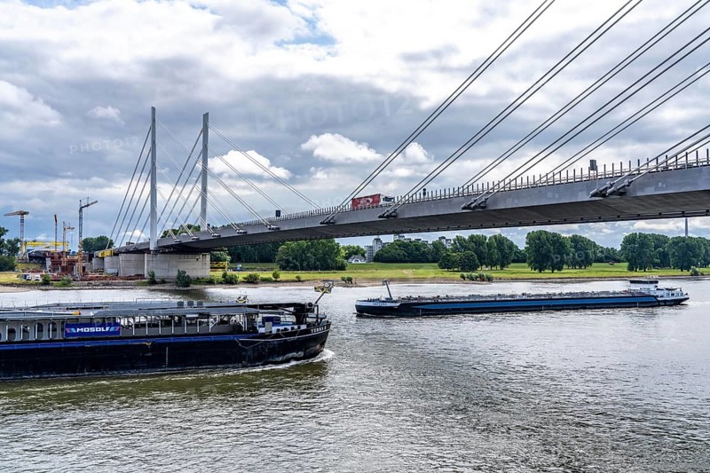 Rhine bridge Duisburg-Neuenkamp, the A40 motorway, start of construction of the second bridge, bridge piers and the first bridge segment are erected on the Neuenkamp side of the Rhine, cargo ship on the Rhine, North Rhine-Westphalia, Germany