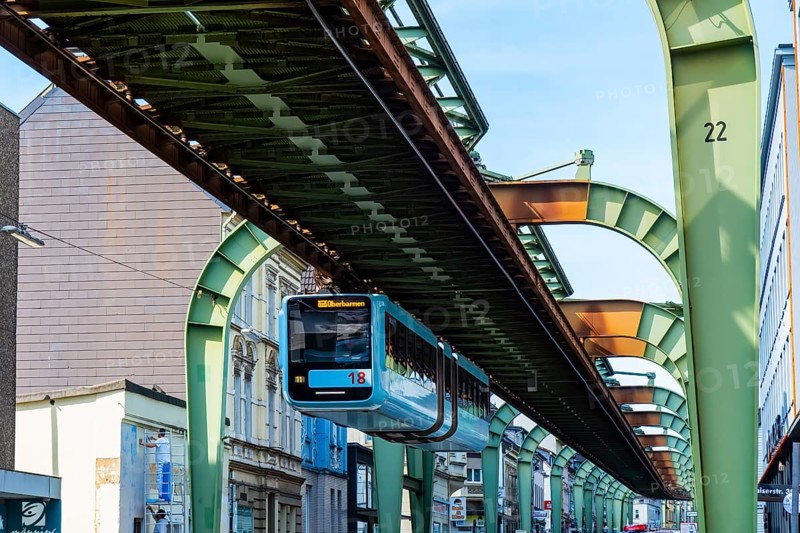 The Wuppertal suspension railway runs through Vohwinkel in front of buildings from the Wilhelminian era near the Bruch stop in Wuppertal, Germany