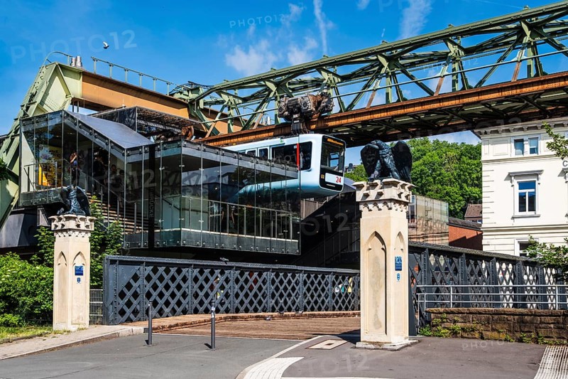 A suspension railway leaves the AdlerbrÃ¼cke stop, Wuppertal, Germany