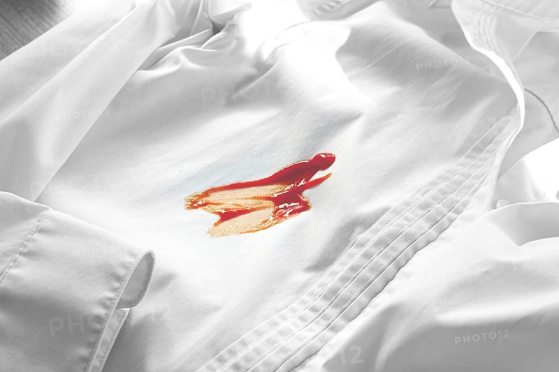 White shirt stained with ketchup, no people, close-up, selective focus