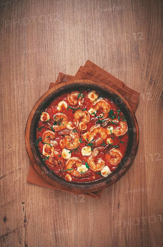Saganaki with shrimp, in a clay pan, Greek dish, shrimp in tomato sauce, feta cheese, homemade, no people