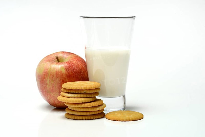Cracker with glass of milk and apple