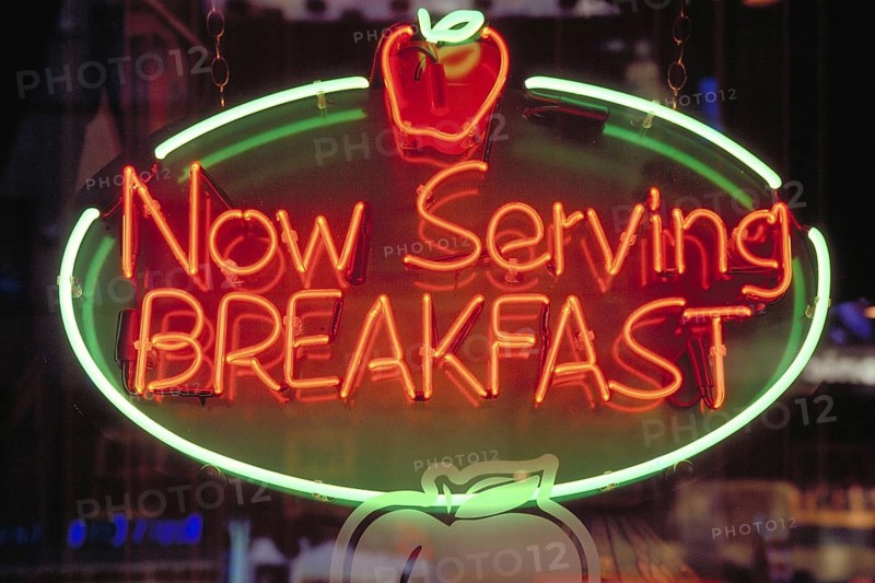 Morning illuminated advertising at a restaurant, New York City, USA