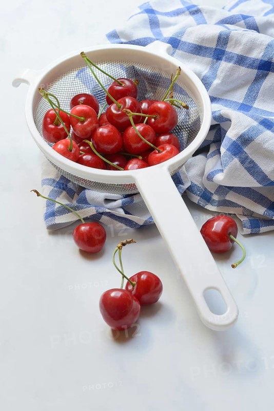 Sweet cherries in sieve, Prunus avium, bird cherry