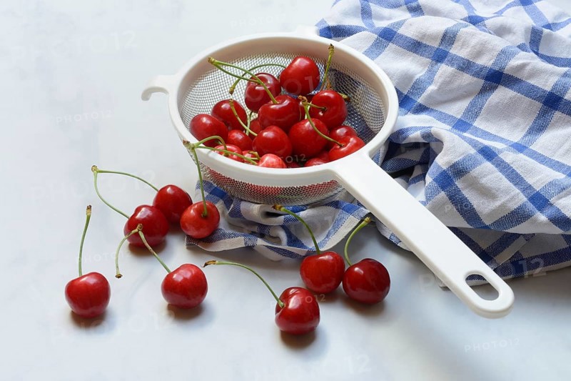 Sweet cherries in sieve, Prunus avium, bird cherry