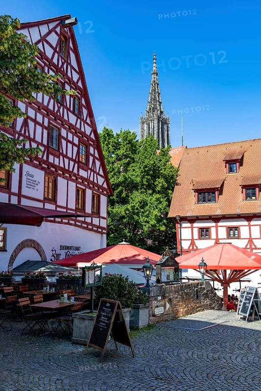 Restaurant with beer garden in a half-timbered house, behind the tower of Ulm Minster, Ulm, Baden-WÃ¼rttemberg, Germany