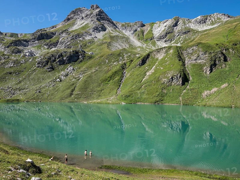 HIker at lake Engeratsgundsee, mountain range between Oberstdorf and Bad Hindelang, Allgaeu, Bavaria, Germany